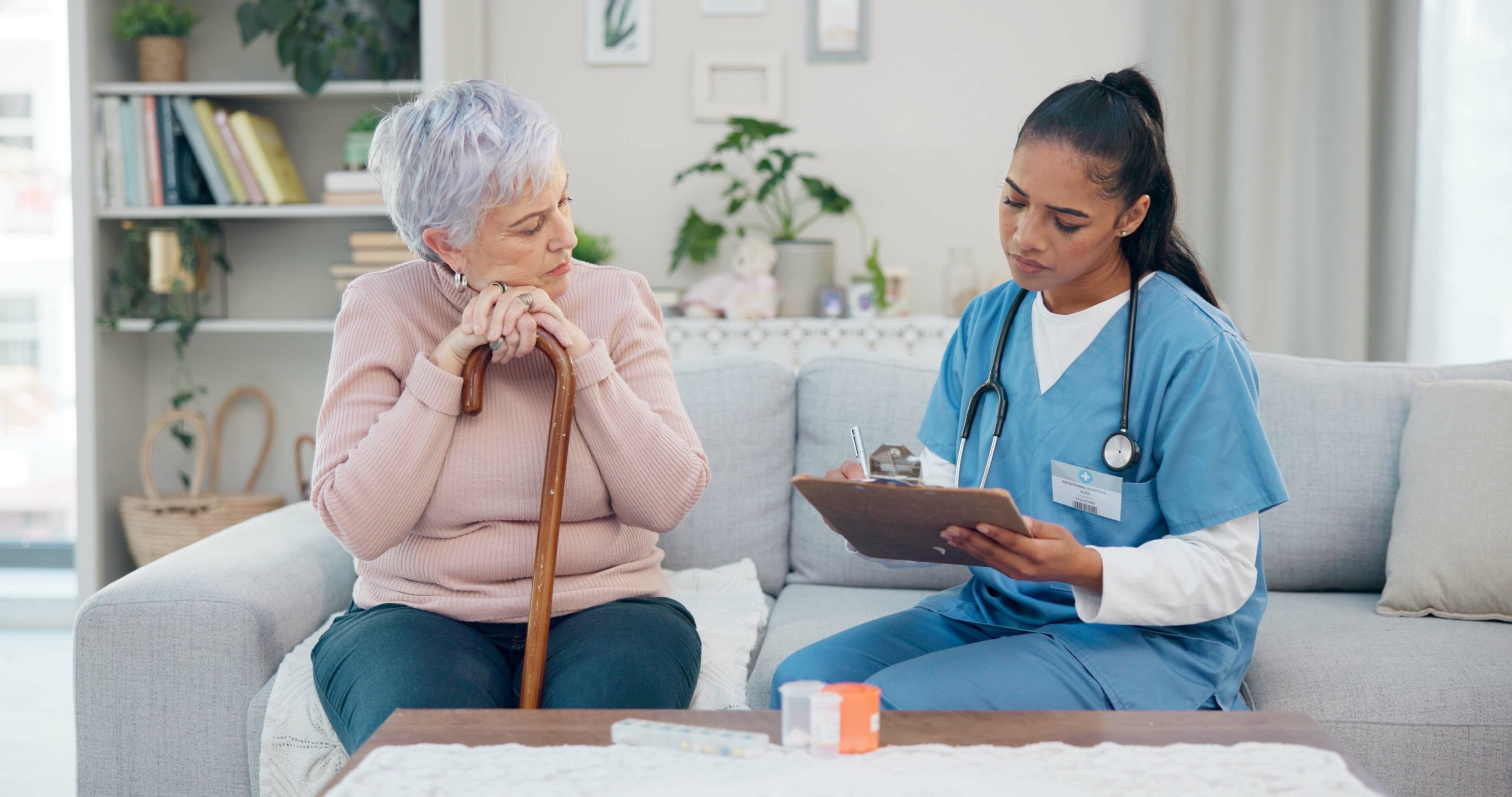 Clipboard, senior woman and nurse talking, ask question or writing client info, medical summary or healthcare survey. Checklist, home and retirement caregiver speaking to elderly patient about pills.